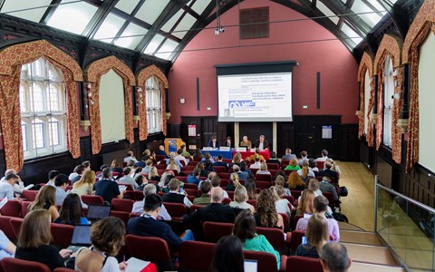 Panel presenting in front of an audience at Divinity School Lecture theatre